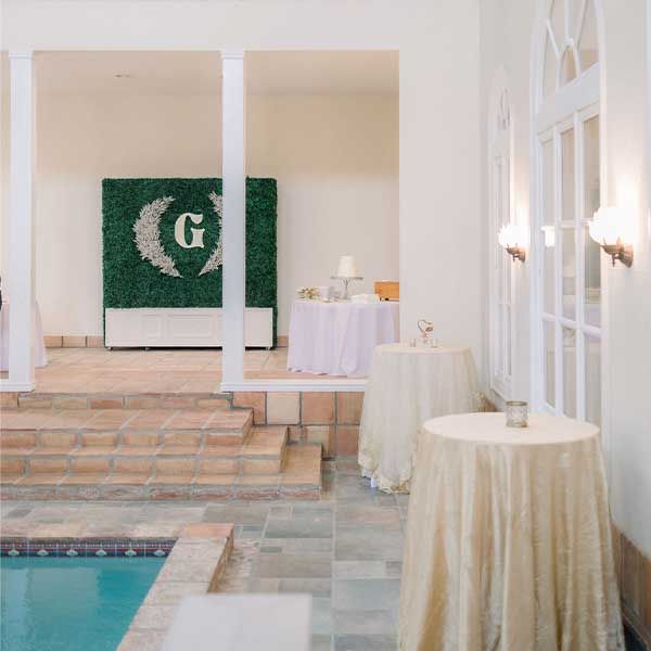 Indoor pool and cocktail tables in the large gathering area.